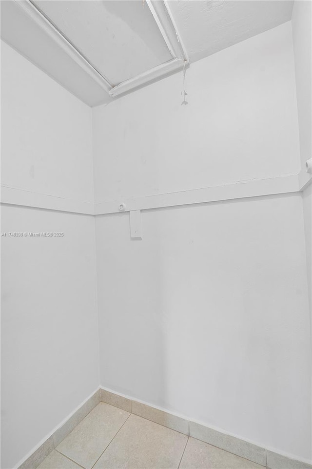 spacious closet featuring tile patterned flooring