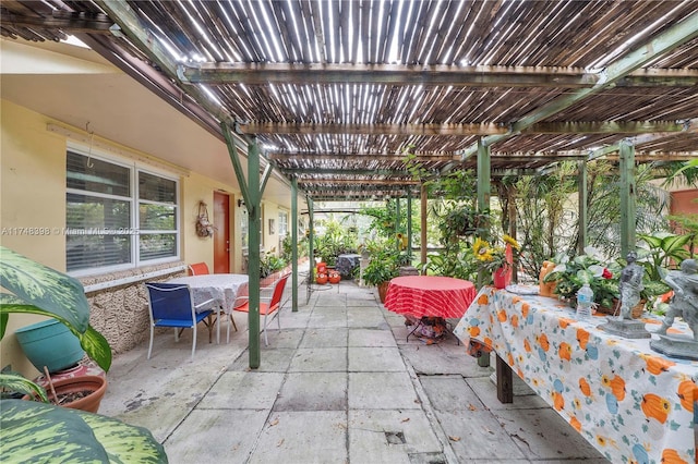 view of patio featuring a pergola and outdoor dining space