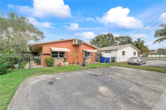 view of front of property with a front lawn and stucco siding