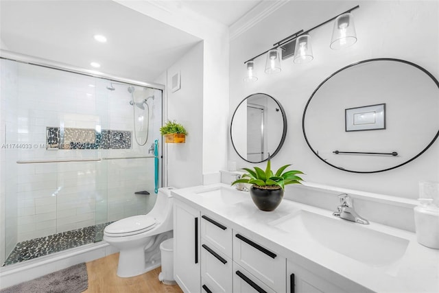 bathroom featuring a shower with shower door, ornamental molding, toilet, wood-type flooring, and vanity