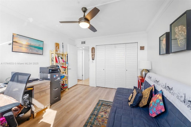 office featuring light wood-type flooring, ceiling fan, and ornamental molding