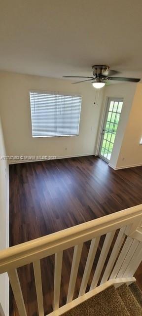 interior space featuring ceiling fan and dark hardwood / wood-style flooring