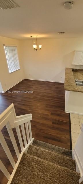 staircase with hardwood / wood-style floors