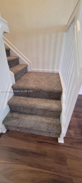 stairs with hardwood / wood-style floors