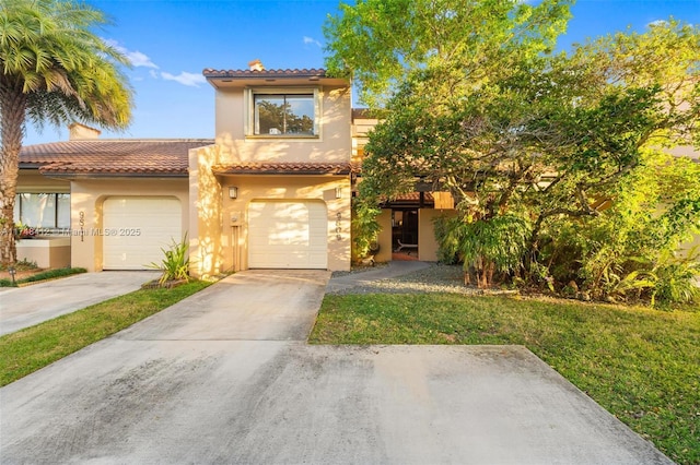 mediterranean / spanish-style house featuring a front yard and a garage