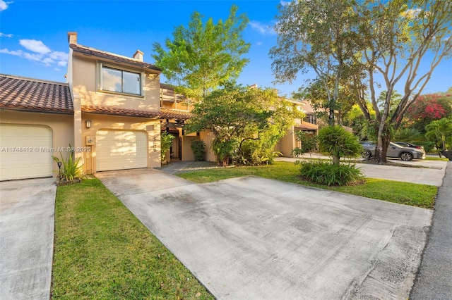 mediterranean / spanish home with a front yard and a garage