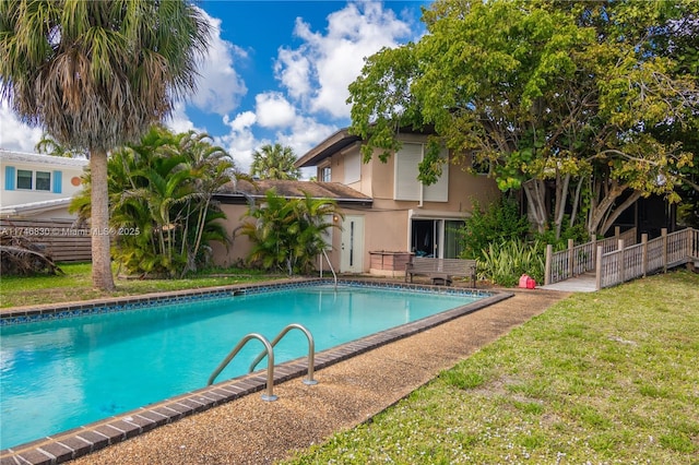 view of pool with a lawn