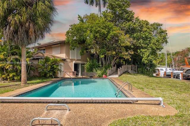 pool at dusk with a lawn