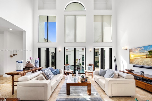 living room featuring french doors and a towering ceiling