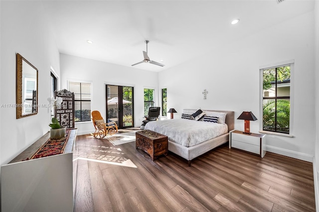 bedroom featuring multiple windows, french doors, and hardwood / wood-style flooring