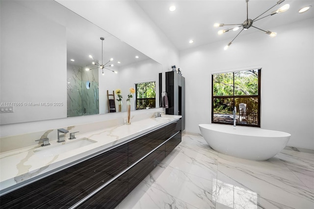 bathroom featuring independent shower and bath, vanity, and a notable chandelier