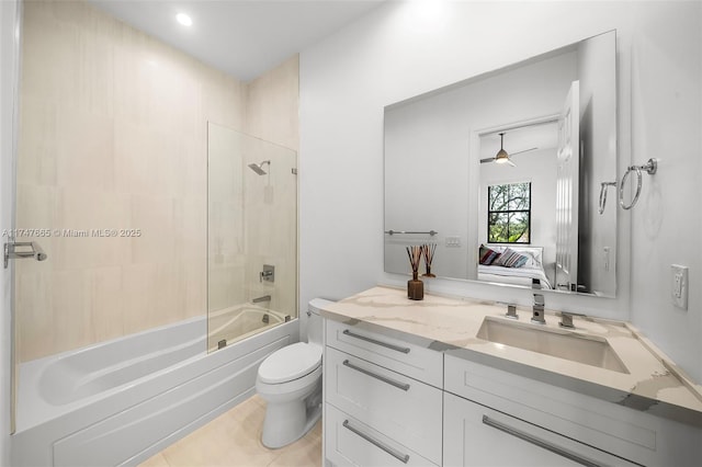full bathroom with vanity, tiled shower / bath, toilet, and tile patterned floors