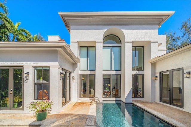 rear view of house with a patio and french doors