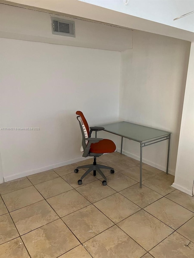 office with baseboards, visible vents, and light tile patterned flooring