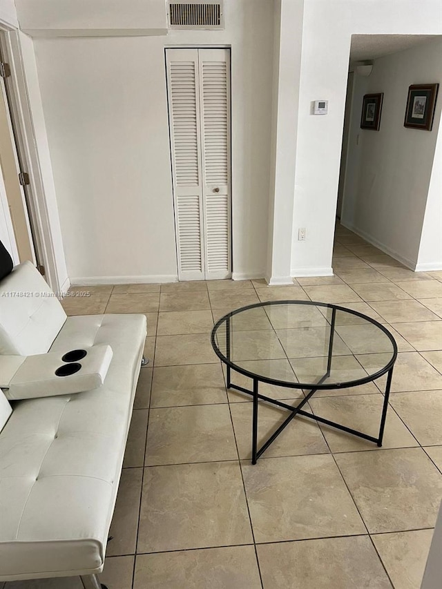 interior space with tile patterned flooring, visible vents, and baseboards