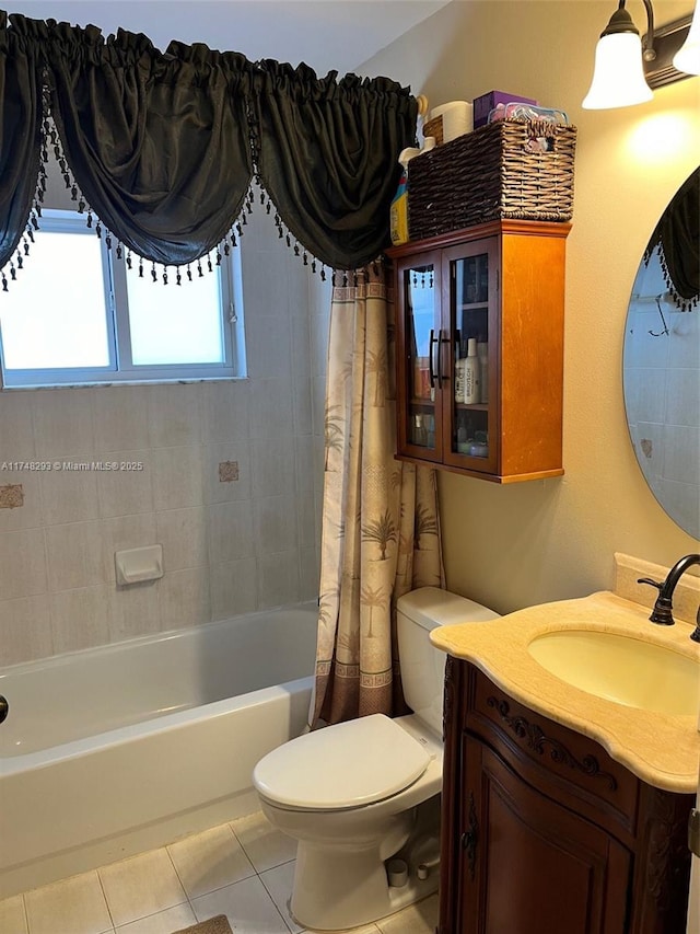 full bath featuring tile patterned floors, toilet, vanity, and shower / bath combo with shower curtain