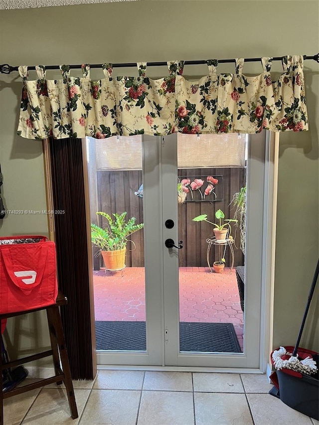 doorway featuring tile patterned flooring and french doors