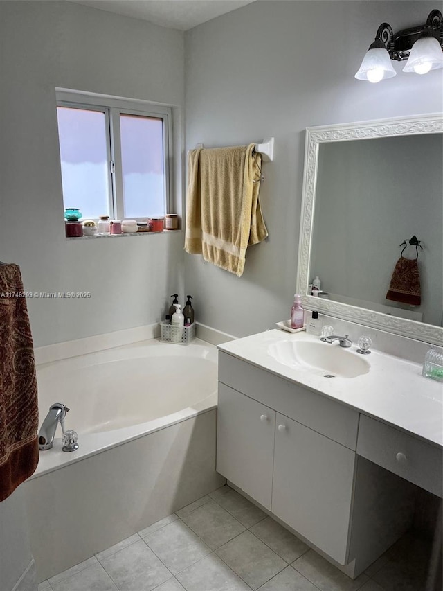 bathroom with tile patterned floors, vanity, and a garden tub