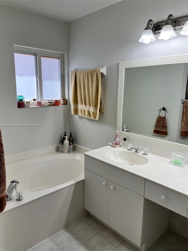 full bathroom featuring vanity, a bath, and tile patterned flooring