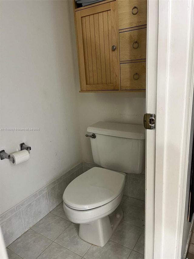 bathroom featuring toilet and tile patterned floors