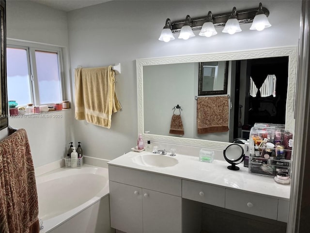 full bath with vanity and a bath