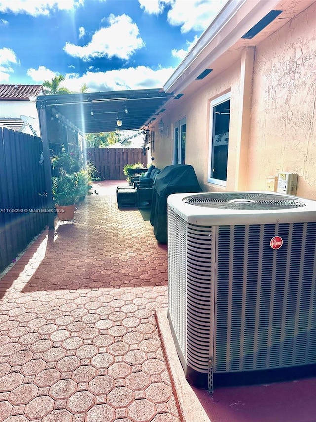 view of patio / terrace featuring central air condition unit and fence private yard