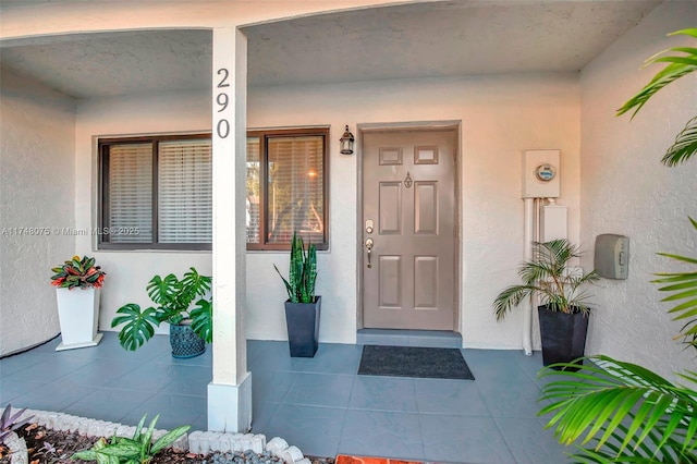 entrance to property with stucco siding