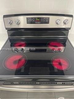 interior details with stainless steel range with electric stovetop