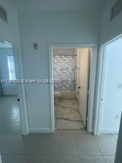 hallway with light tile patterned floors
