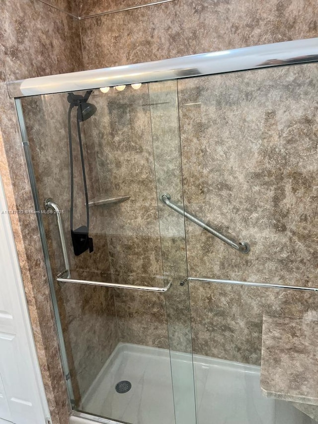 bathroom with a shower with shower door