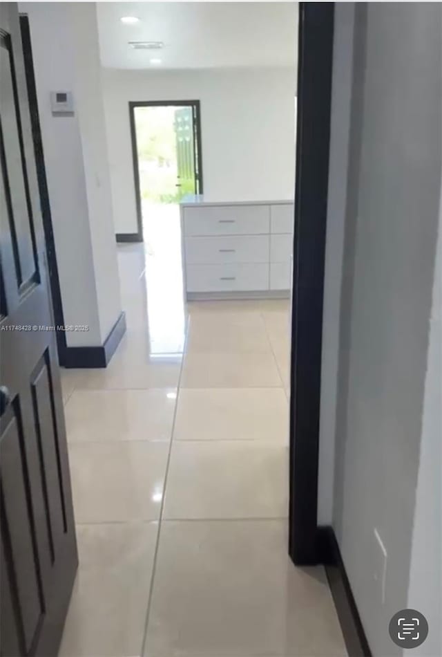 hallway featuring light tile patterned flooring