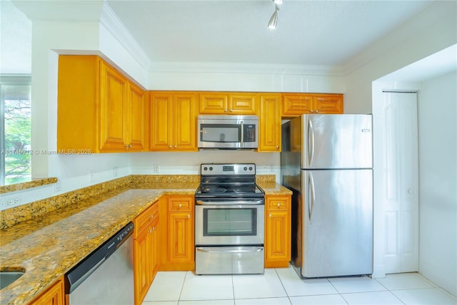 kitchen with appliances with stainless steel finishes, light tile patterned floors, light stone counters, and crown molding