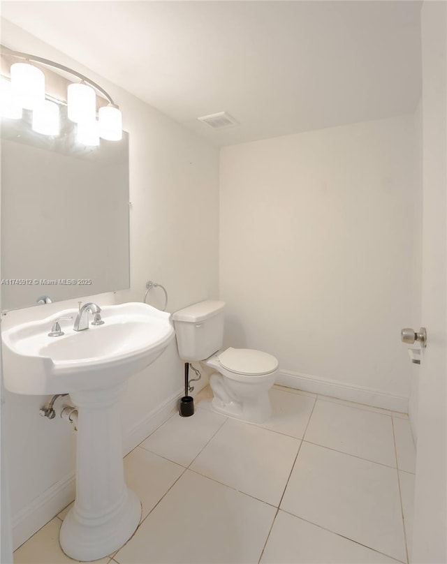 bathroom with tile patterned floors and toilet