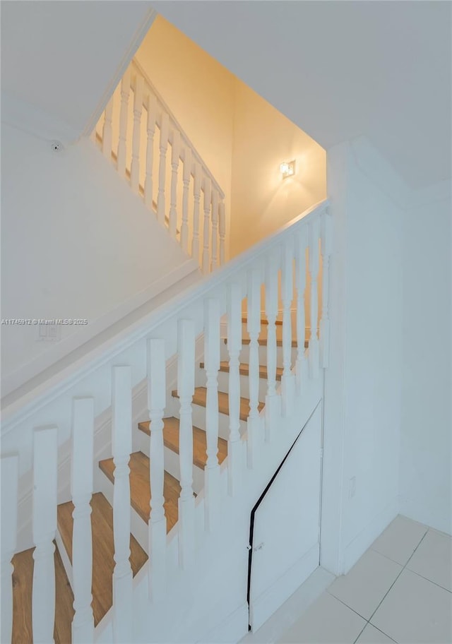 stairway with tile patterned flooring