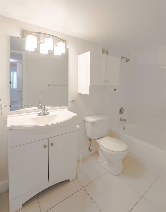 bathroom featuring toilet, vanity, tile patterned flooring, and shower / bathtub combination