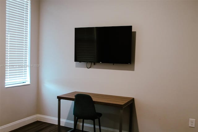 office space with dark wood-type flooring