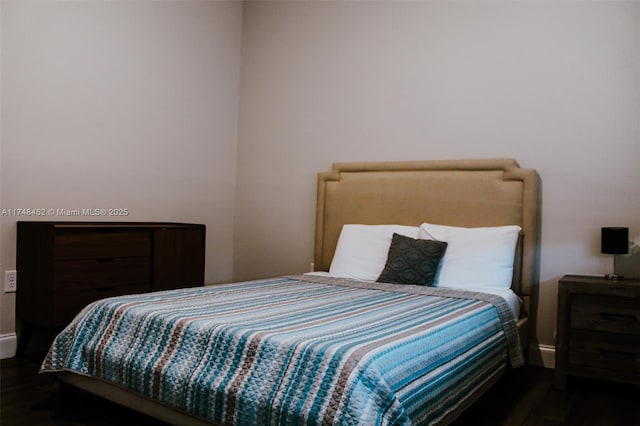 bedroom featuring dark hardwood / wood-style flooring