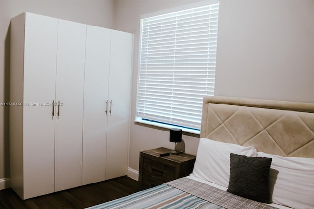 unfurnished bedroom with dark wood-type flooring