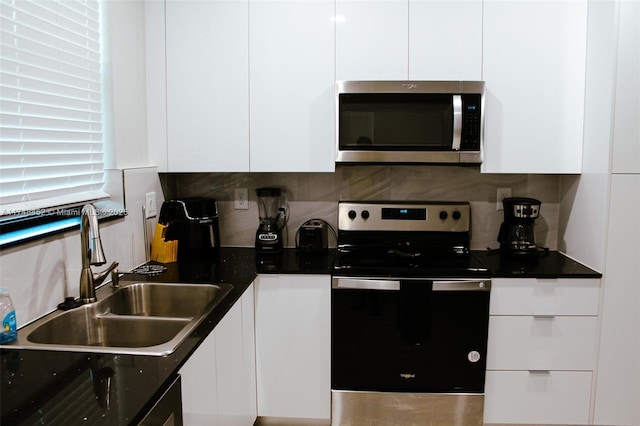 kitchen with sink, white cabinets, tasteful backsplash, and stainless steel appliances