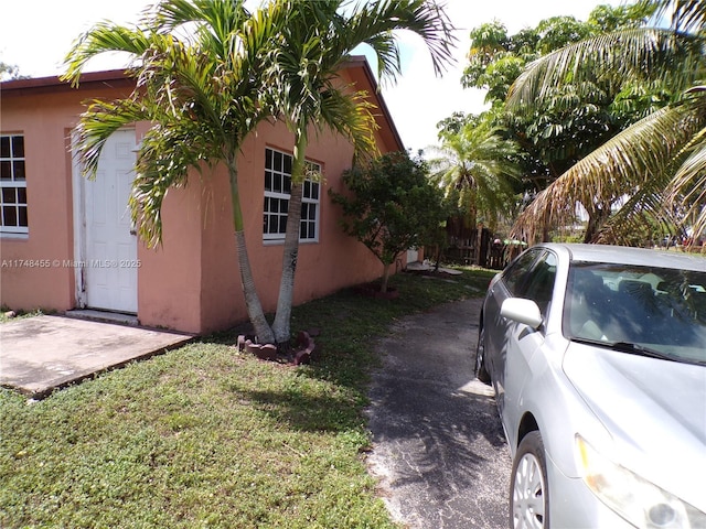 view of home's exterior with a lawn