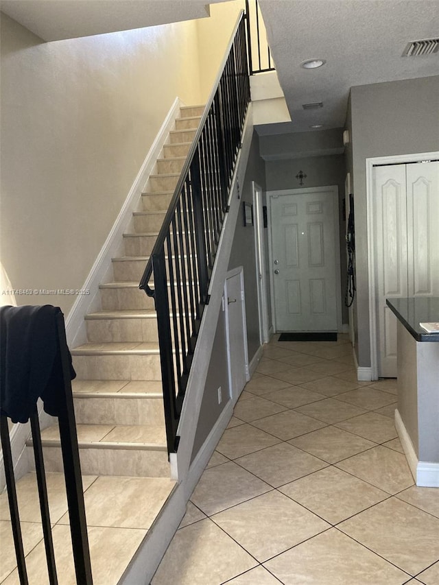 staircase with tile patterned flooring