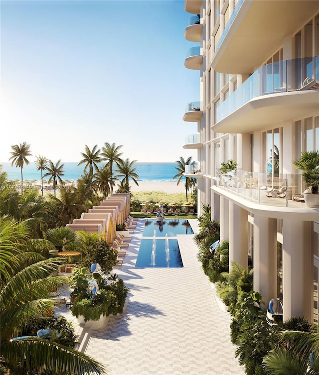 view of swimming pool featuring a beach view and a water view