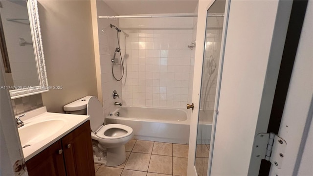 full bathroom with toilet, vanity, tile patterned flooring, and tiled shower / bath