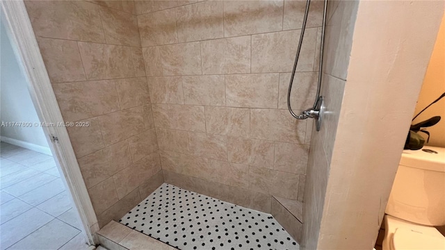 bathroom featuring a shower stall, toilet, and tile patterned floors