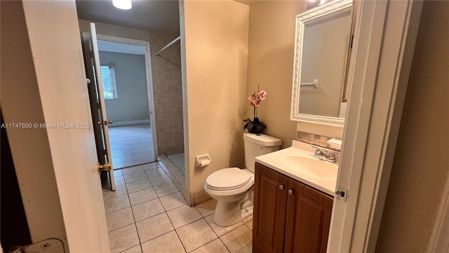 bathroom featuring toilet, vanity, tile patterned flooring, and walk in shower