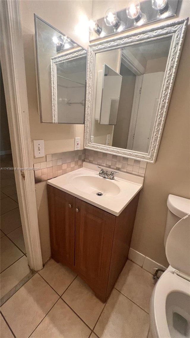 bathroom featuring vanity, decorative backsplash, toilet, and tile patterned flooring