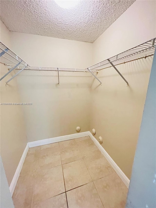 spacious closet featuring tile patterned floors