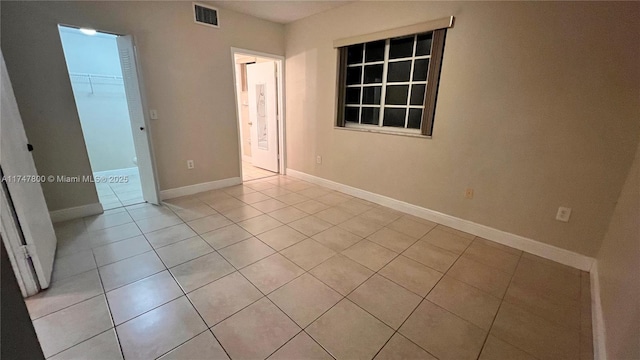 unfurnished room featuring light tile patterned floors