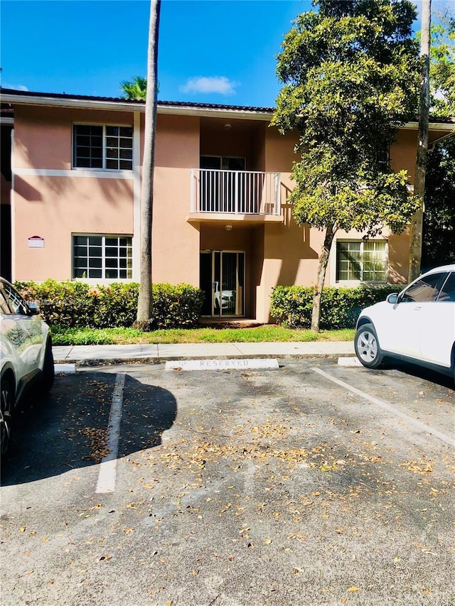 view of building exterior featuring uncovered parking