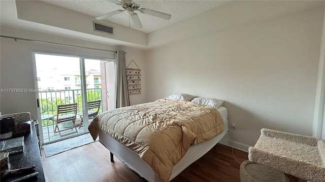 bedroom featuring a textured ceiling, hardwood / wood-style floors, access to outside, and ceiling fan